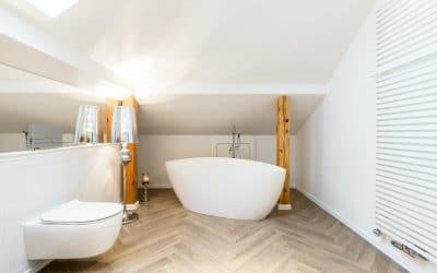 White attic bathroom with bathtub