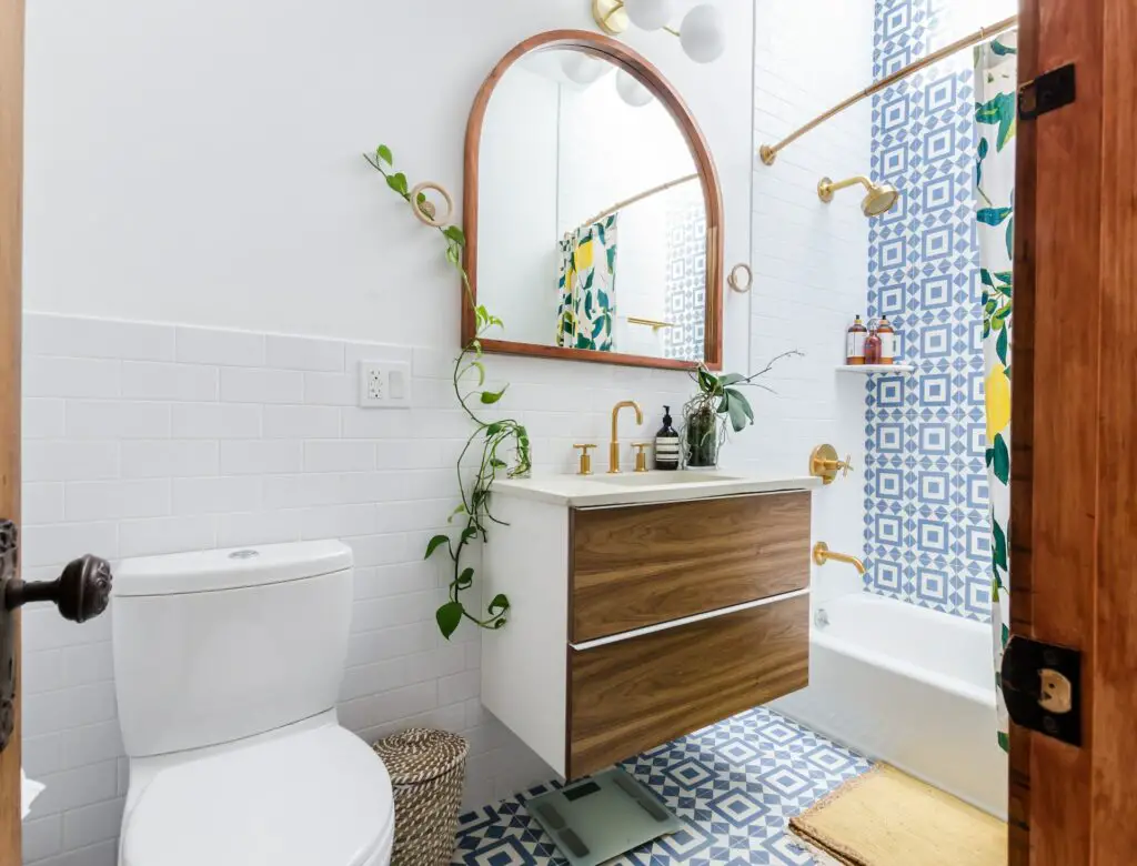 Blue and white geometric patterned cement tile on floor and up main shower wall.