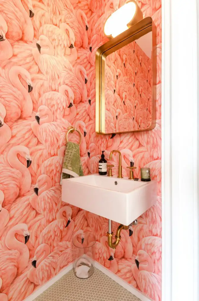 Pink flamingo wallpaper in small half bath.