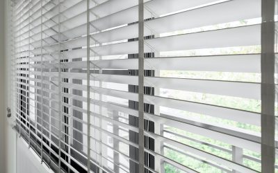 Closeup white color wooden blind with white ladder tape curtains.